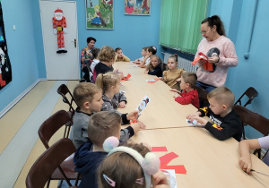 Pani bibliotekarka prezentuje sposób wykonania pracy.