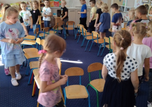 Dzieci uczestniczą w zabawie "gorące krzesła".